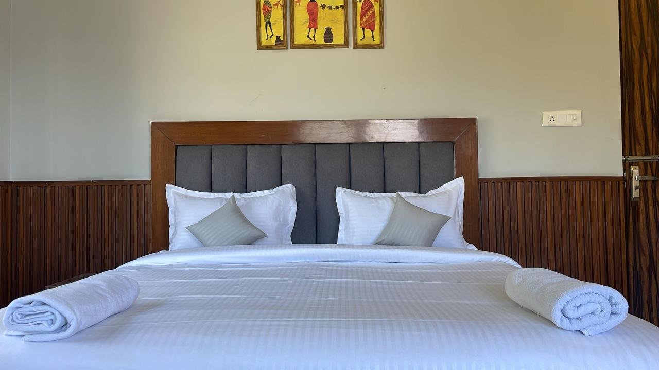 Cozy bedroom with wooden paneling and decorative artwork